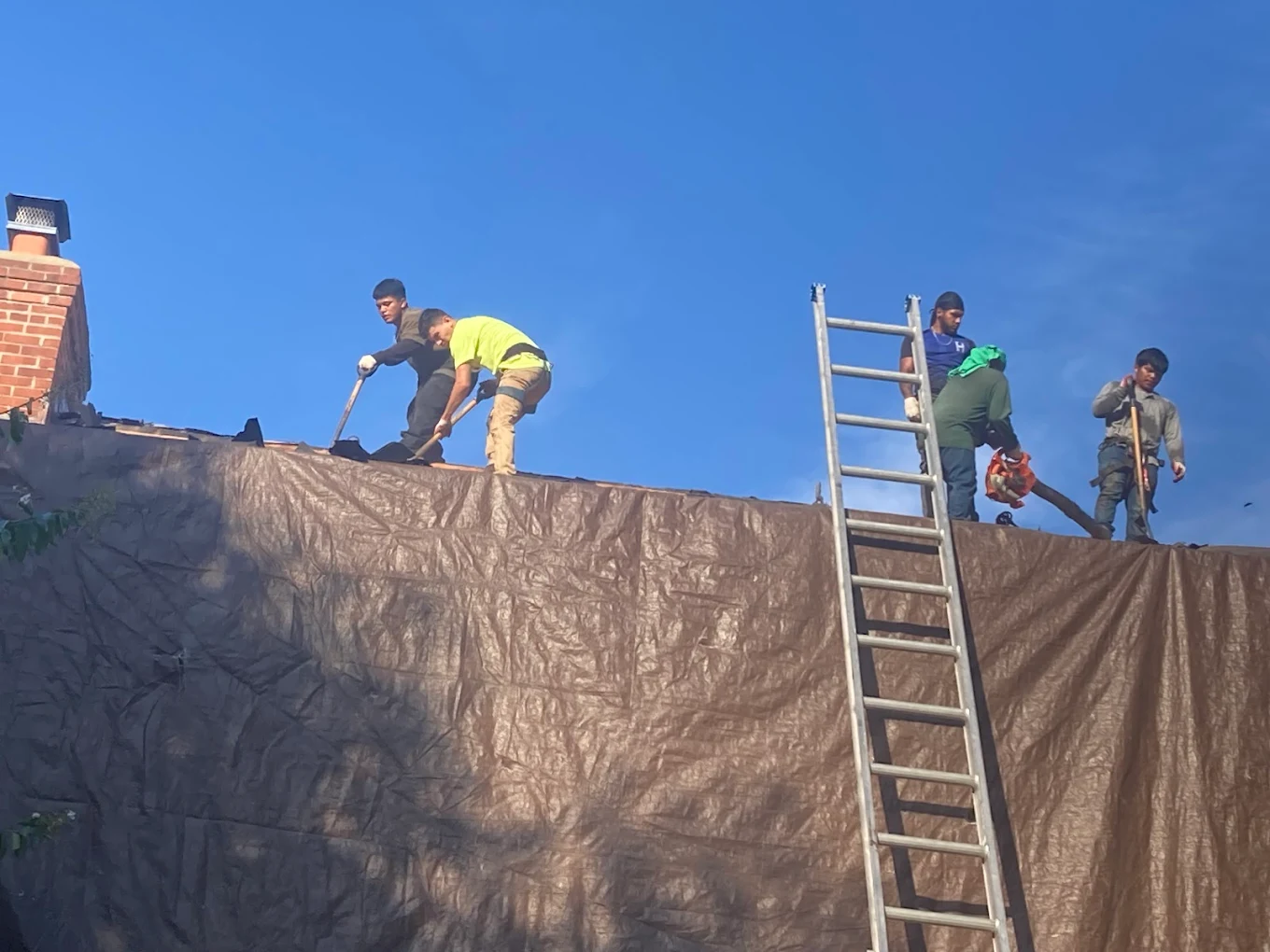 Espinoza Slate Roofing crew performing a roof tear-off and replacement